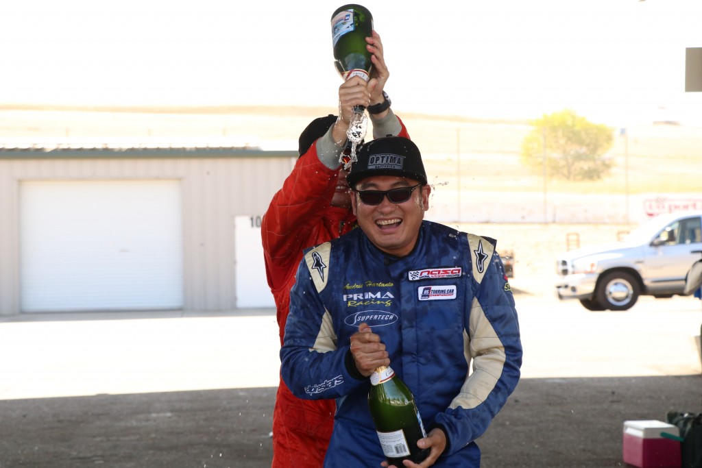 Hartanto is ambushed by Speed SF's Patrick Chio with champagne during the podium ceremony